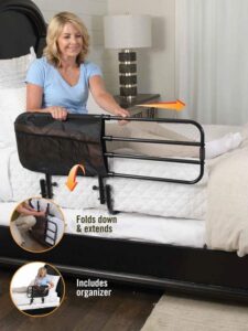 Image of a woman, seated in a bed, using an adjustable length bed rail.