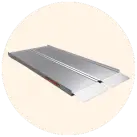 Image of an aluminum suitcase ramp against a cream circular background