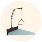 Image of a trapeze bar on headboard of a hospital bed, against a cream circular background.