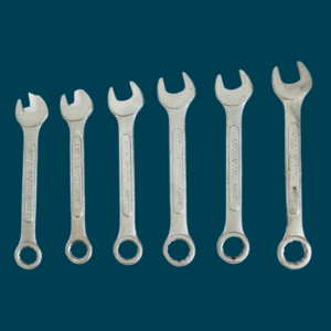 Image of wrenches in different sizes set against a dark teal background.